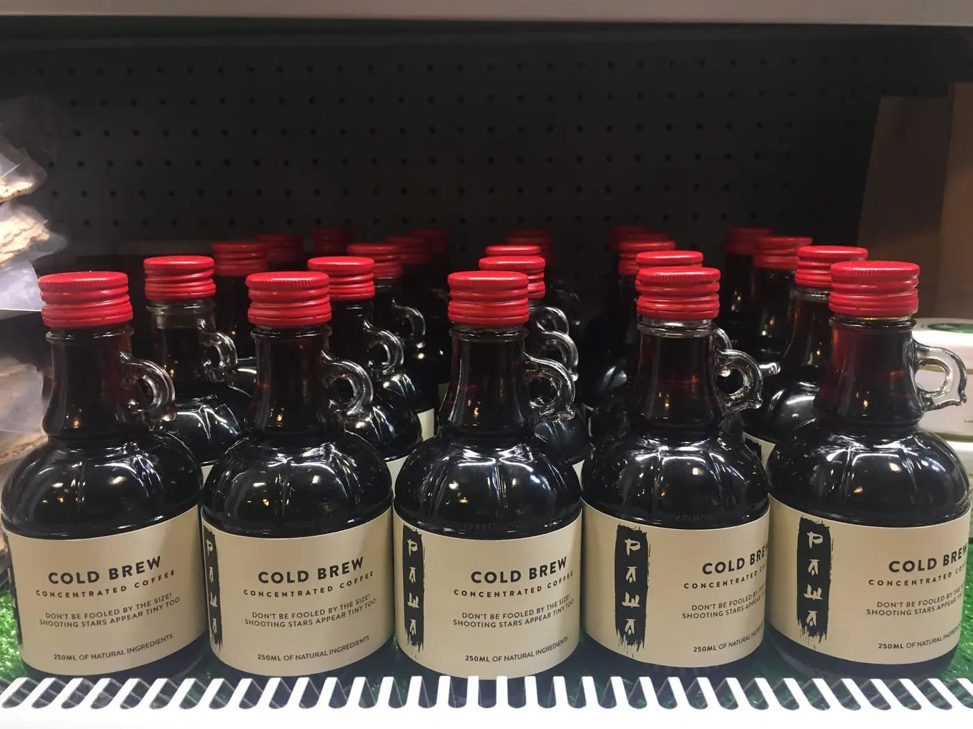 Rows of labelled Pawa cold-brew bottles on a retail shelf